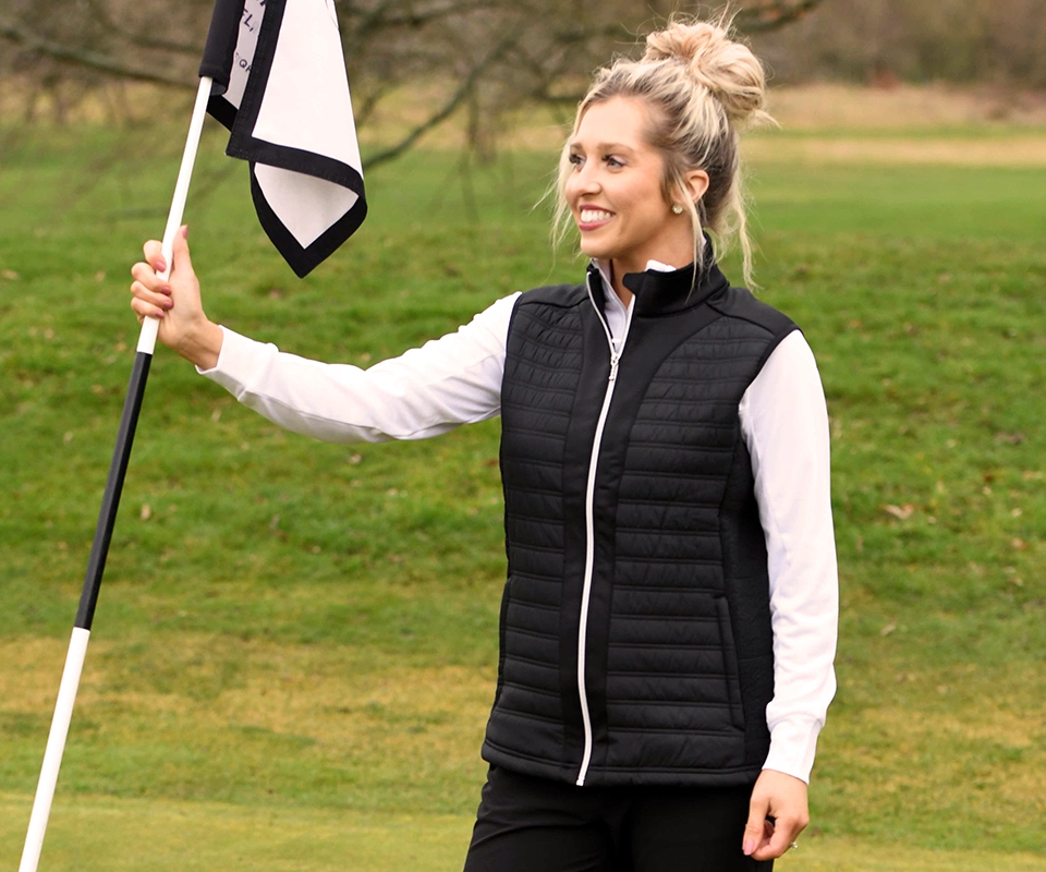 A women holding a flag wearing a ProQuip windproof gilet